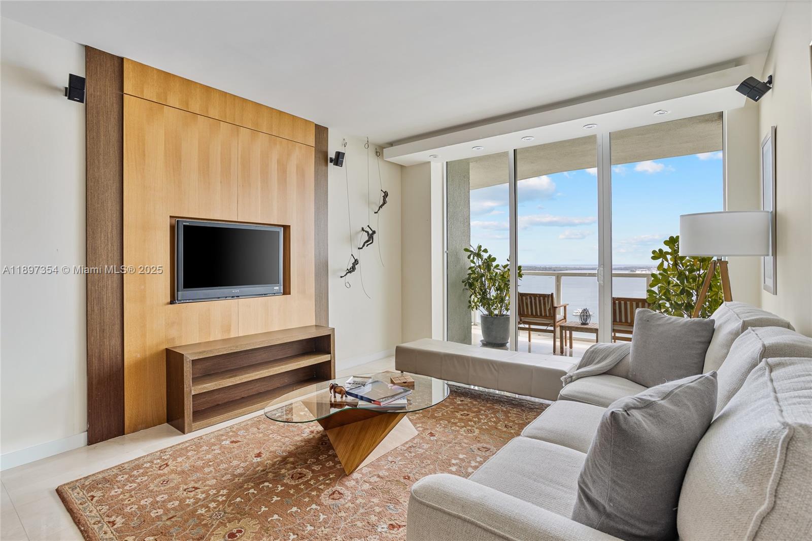 218 Southeast 14th Street, Unit 2105 Miami, FL 33131 - Photo 7 of 36 a living room with furniture and a flat screen tv