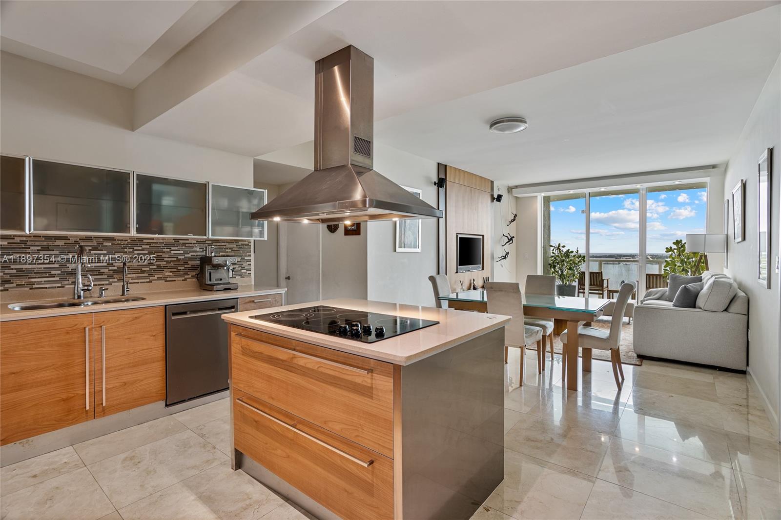 218 Southeast 14th Street, Unit 2105 Miami, FL 33131 - Photo 8 of 36 a kitchen with stainless steel appliances granite countertop a sink and a stove