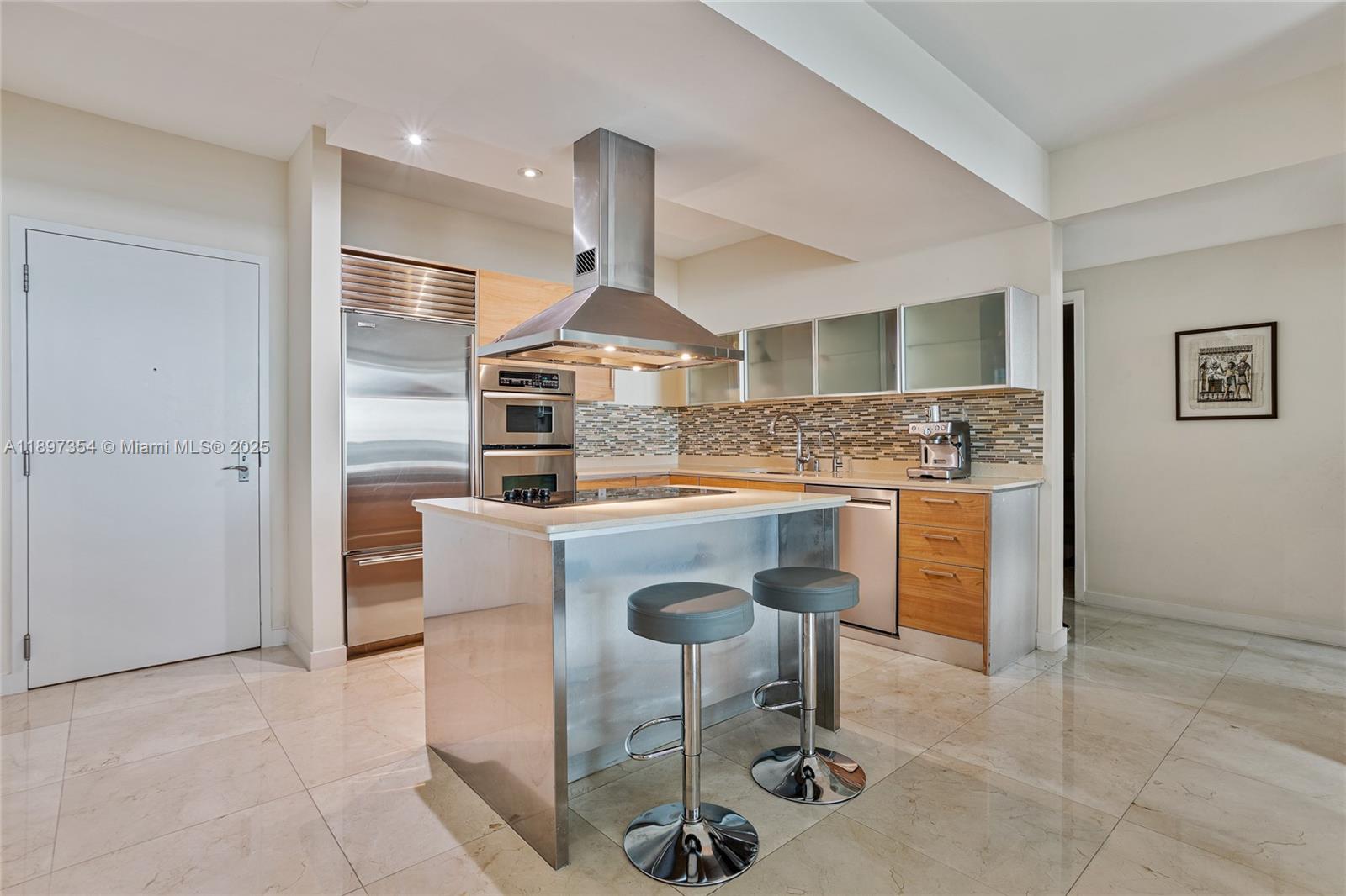 218 Southeast 14th Street, Unit 2105 Miami, FL 33131 - Photo 9 of 36 a kitchen with stainless steel appliances granite countertop a sink and a refrigerator