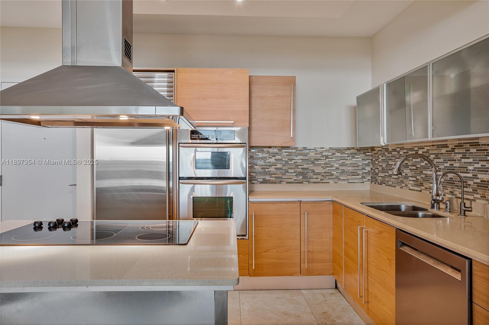 218 Southeast 14th Street, Unit 2105 Miami, FL 33131 - Photo 10 of 36 a kitchen with stainless steel appliances a sink and a refrigerator