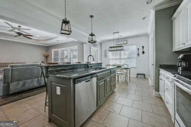 a kitchen with stainless steel appliances granite countertop a stove and a sink
