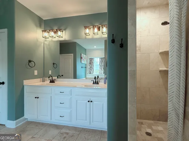a bathroom with a double vanity sink and a mirror