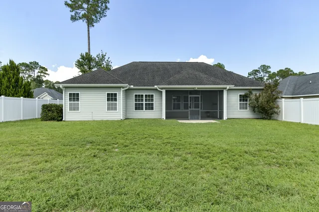 a front view of house with yard and trees