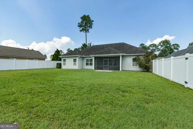 a front view of house with a garden