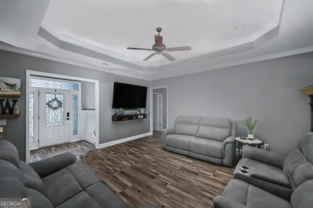 a living room with furniture and a flat screen tv