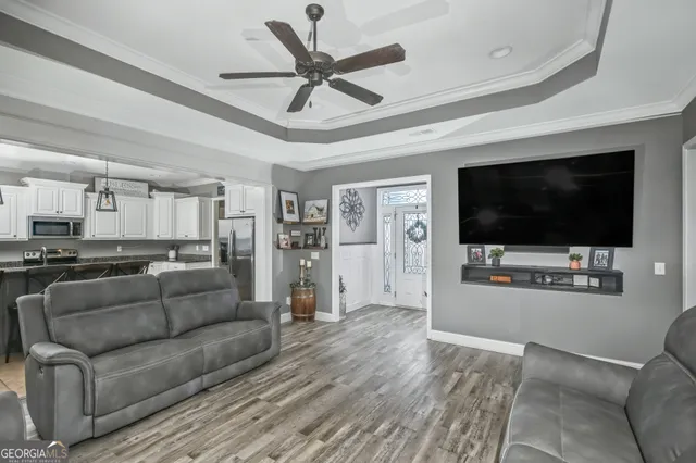 a living room with furniture and a flat screen tv