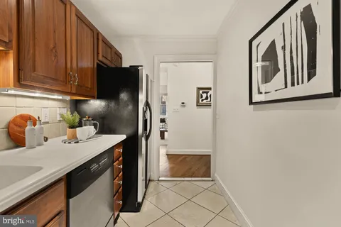 a kitchen with stainless steel appliances a refrigerator and a cabinets