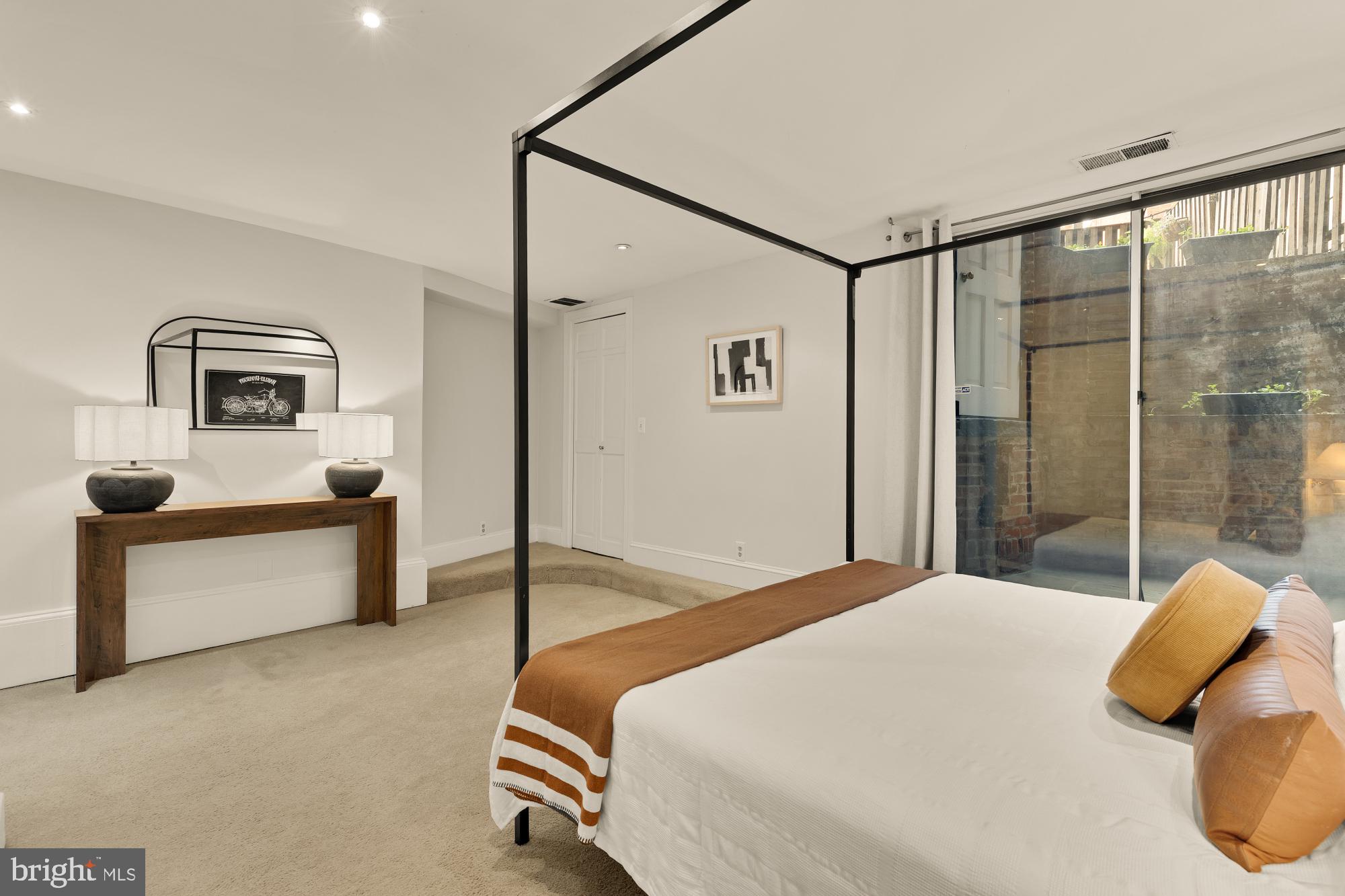 6 Logan Circle Northwest, Unit 2 Washington, DC 20005 - Photo 14 of 27 a bedroom with a bed and a dresser