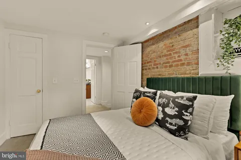 a bedroom with furniture and a window