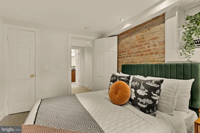 a bedroom with furniture and a window