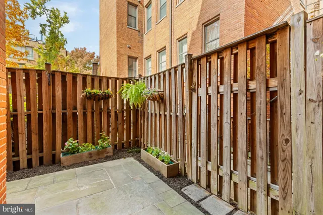 a view of a brick house with many windows