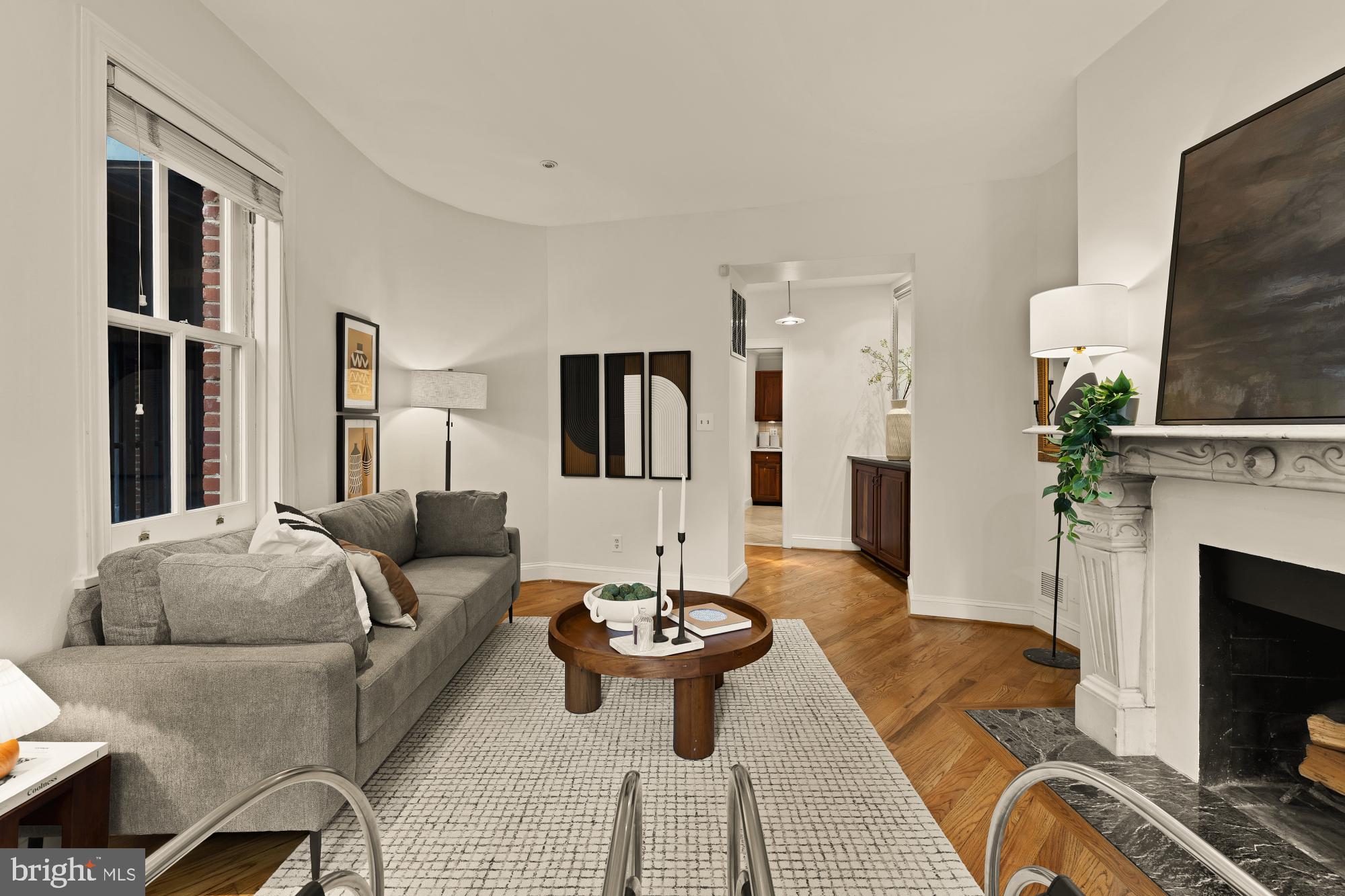 6 Logan Circle Northwest, Unit 2 Washington, DC 20005 - Photo 4 of 27 a living room with furniture a fireplace and a flat screen tv