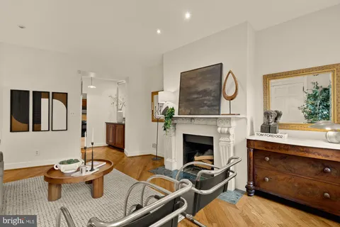 a living room with furniture a fireplace and a window