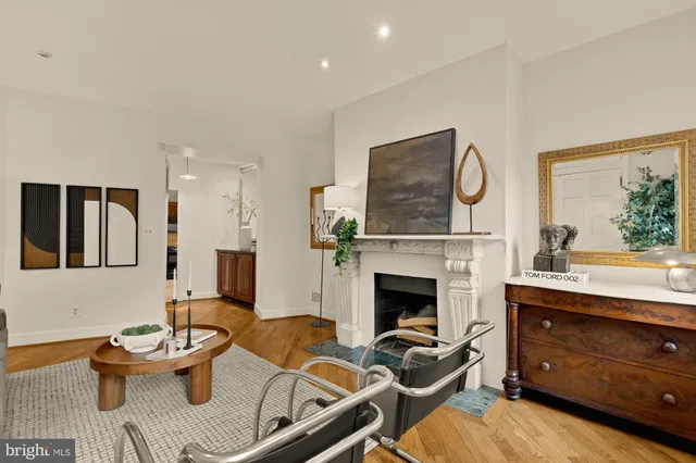 a living room with furniture a fireplace and a window