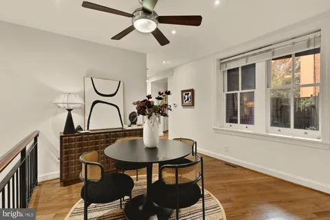 a dining room with furniture a chandelier and wooden floor