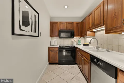 a kitchen with a sink stove and microwave