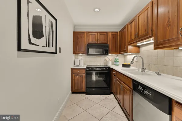 a kitchen with a sink stove and microwave