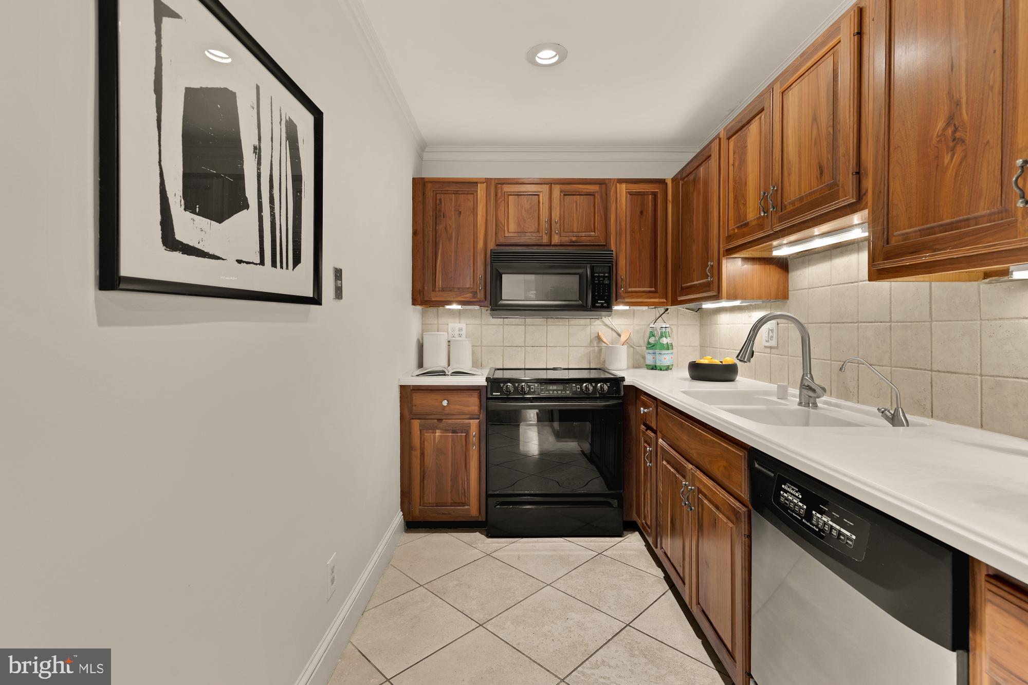 6 Logan Circle Northwest, Unit 2 Washington, DC 20005 - Photo 10 of 27 a kitchen with a sink stove and microwave