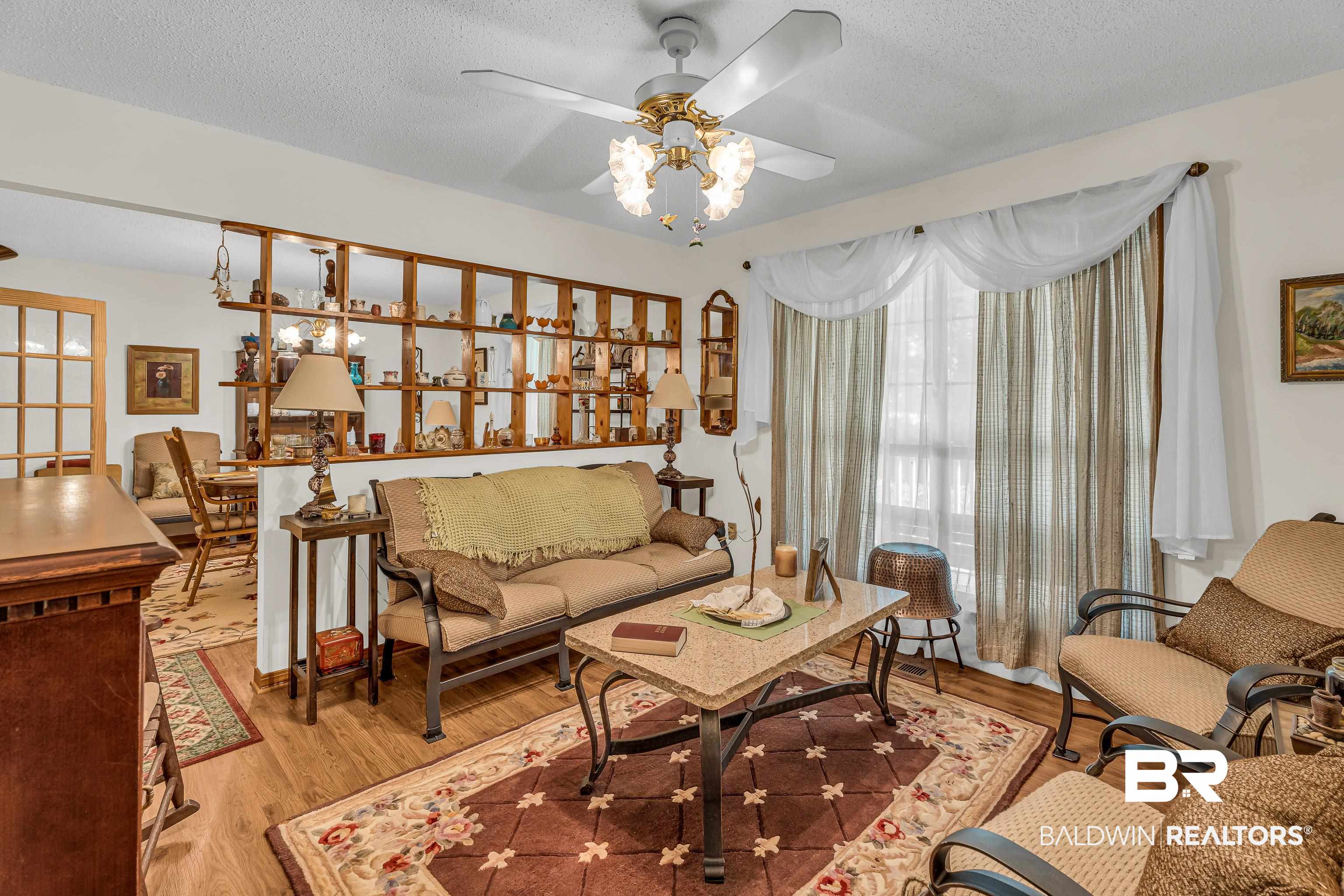 72075 Highway 59 Little River, AL 36550 - Photo 15 of 40 Living area featuring wood finished floors, a textured ceiling, and a ceiling fan