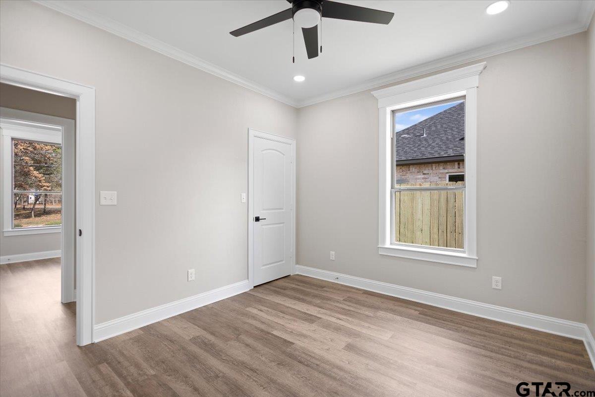 528 West 32nd Street Tyler, TX 75702 - Photo 11 of 29 a view of an empty room with wooden floor and a window