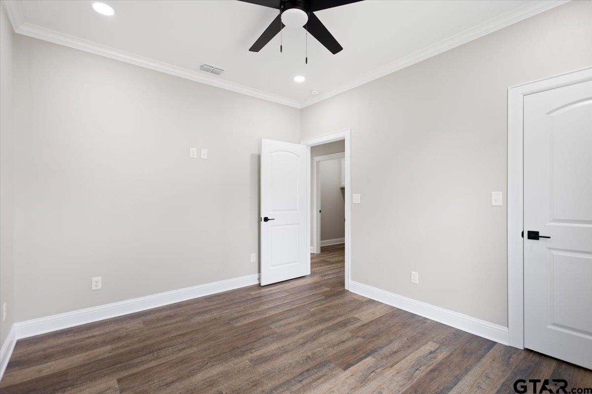 528 West 32nd Street Tyler, TX 75702 - Photo 12 of 29 an empty room with wooden floor and ceiling fan