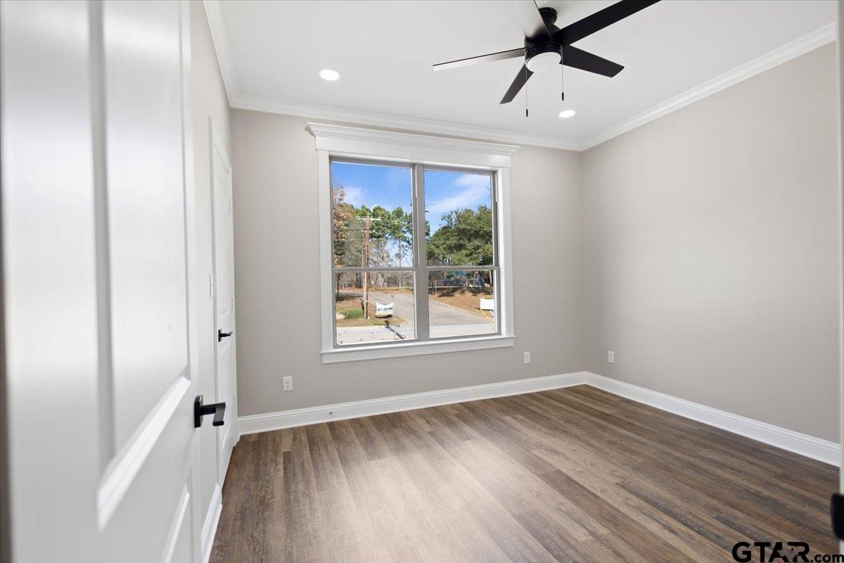528 West 32nd Street Tyler, TX 75702 - Photo 13 of 29 a view of an empty room with wooden floor and a window