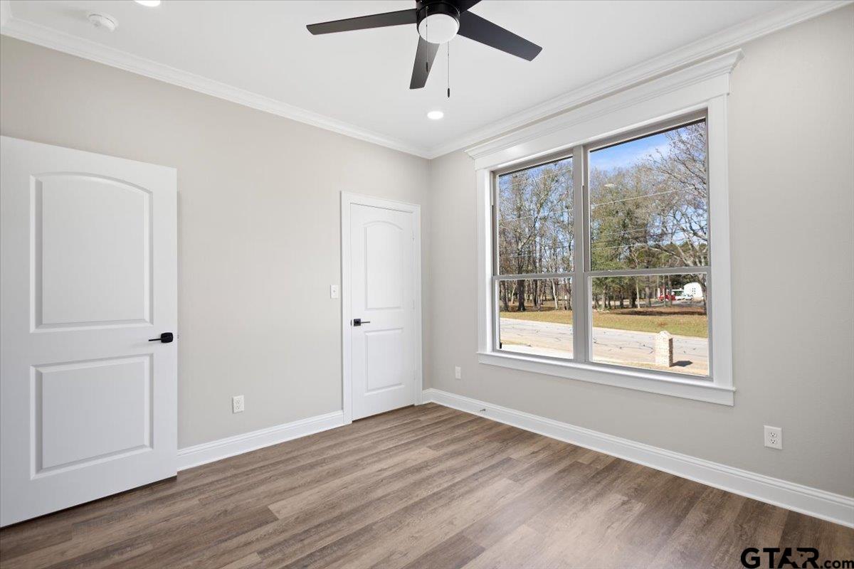 528 West 32nd Street Tyler, TX 75702 - Photo 14 of 29 a view of an empty room with wooden floor and a window