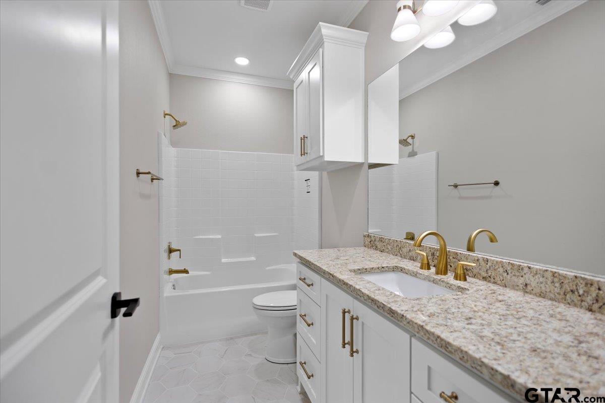 528 West 32nd Street Tyler, TX 75702 - Photo 28 of 29 a bathroom with a granite countertop sink a toilet and shower