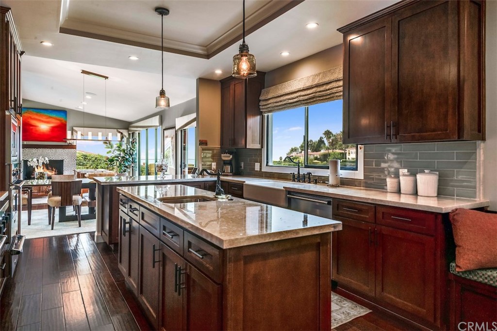 1539 Vía Coronel Palos Verdes Estates, CA 90274 - Photo 18 of 52 a kitchen with stainless steel appliances granite countertop a sink a stove and a wooden cabinets