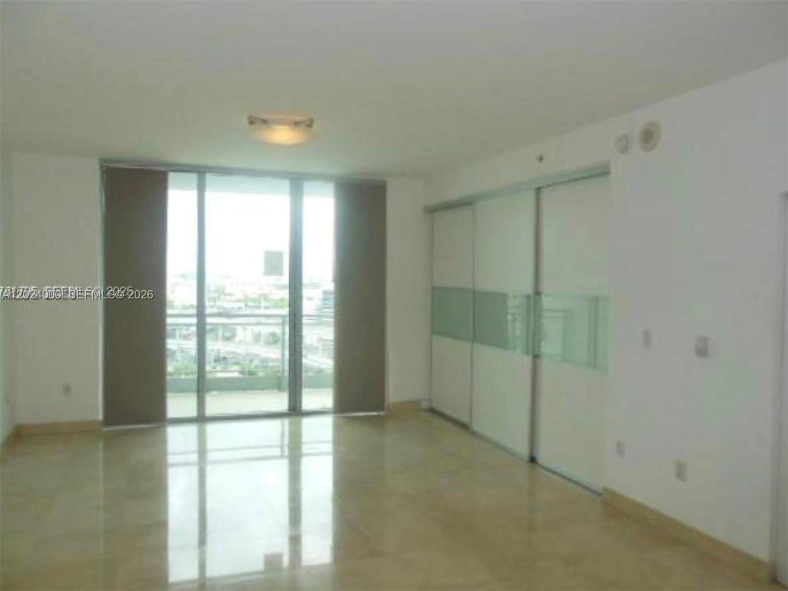 90 Southwest 3rd Street, Unit 1811 Miami, FL 33130 - Photo 2 of 4 a view of an empty room and window