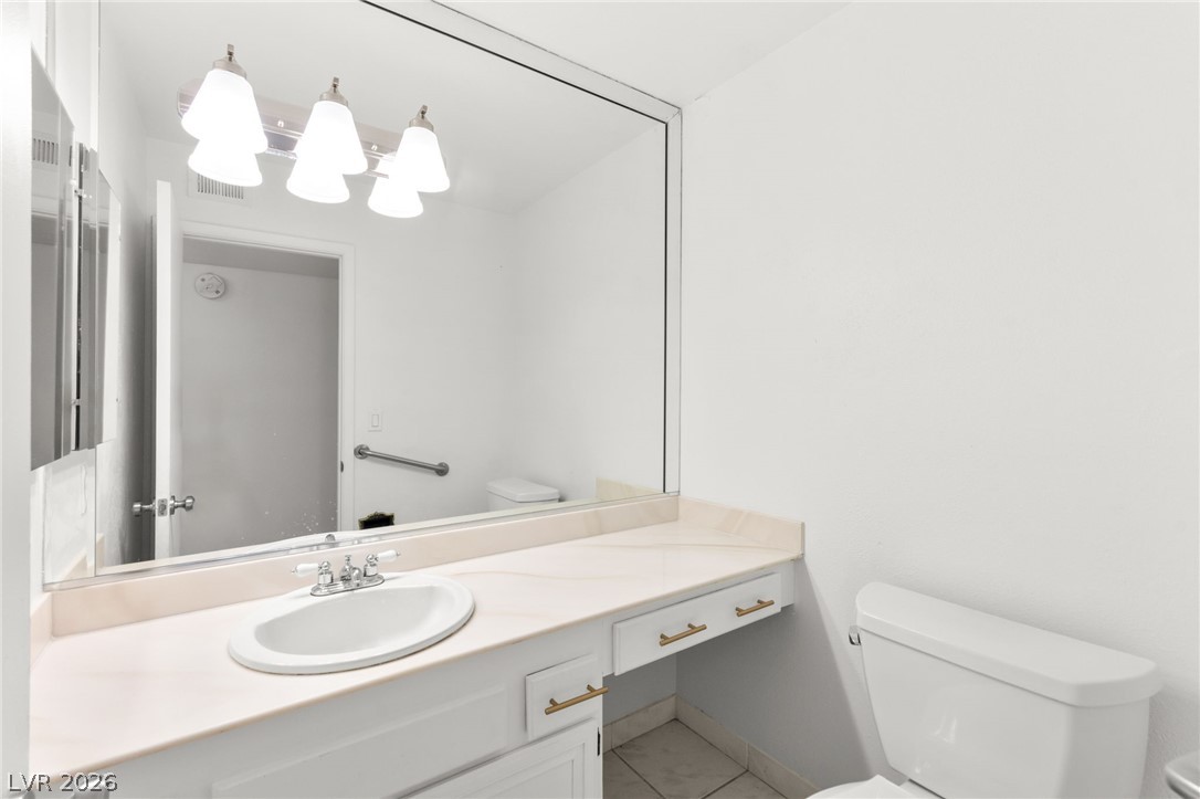 4430 Cranbrook Way Las Vegas, NV 89103 - Photo 27 of 50 A pristine bathroom featuring a wide vanity, large mirror, and clean, functional fixtures.
