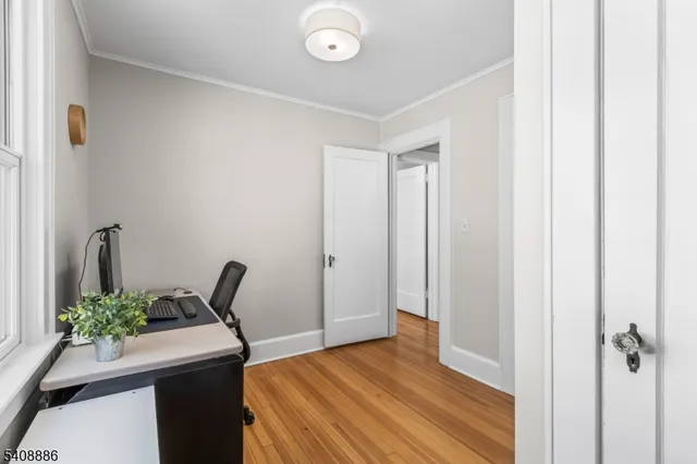 a bedroom with a bed and a potted plant