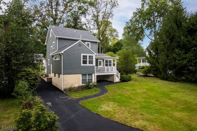a front view of a house with yard porch and green space