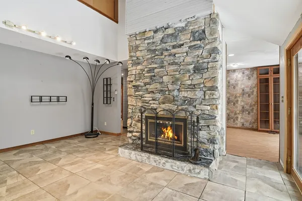 a view of an empty room with fire place