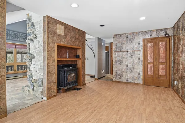 a view of an empty room with a fireplace and a window