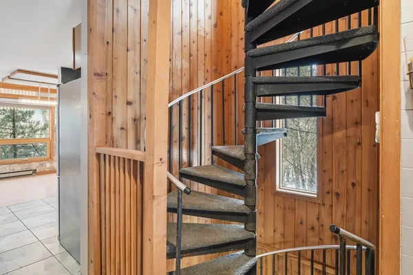 a room with pool table and a large window