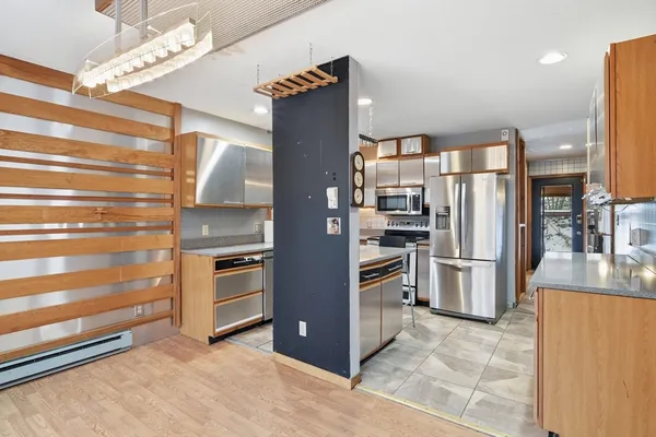 a kitchen with stainless steel appliances a refrigerator and a stove