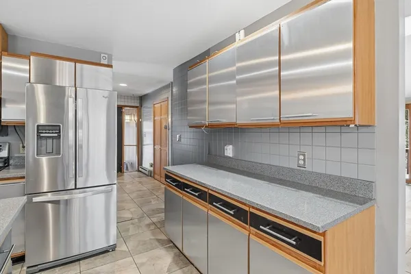 a kitchen with stainless steel appliances a refrigerator and a sink