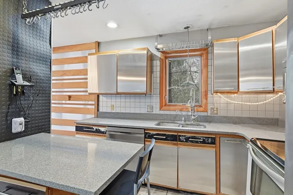 a kitchen with stainless steel appliances a sink a stove and a refrigerator