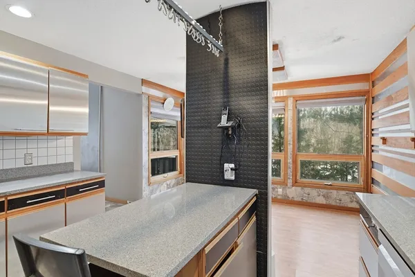 a room with pool table and windows