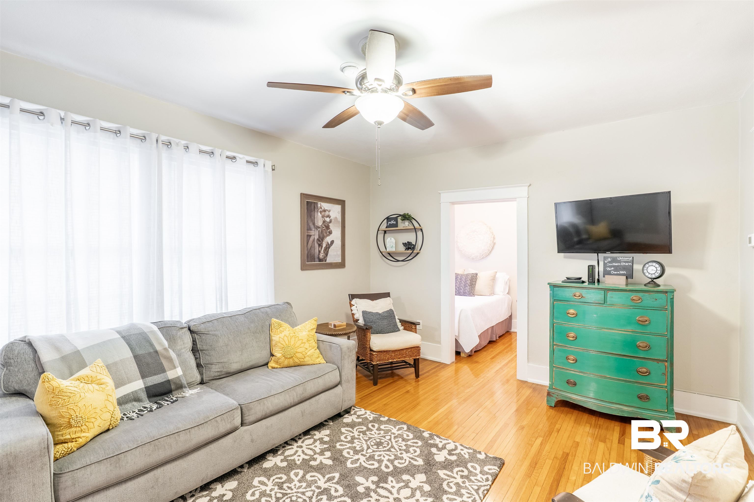 1600 Government Street, Unit 3F Mobile, AL 36604 - Photo 13 of 18 Living room featuring a ceiling fan, light wood-style flooring, and baseboards