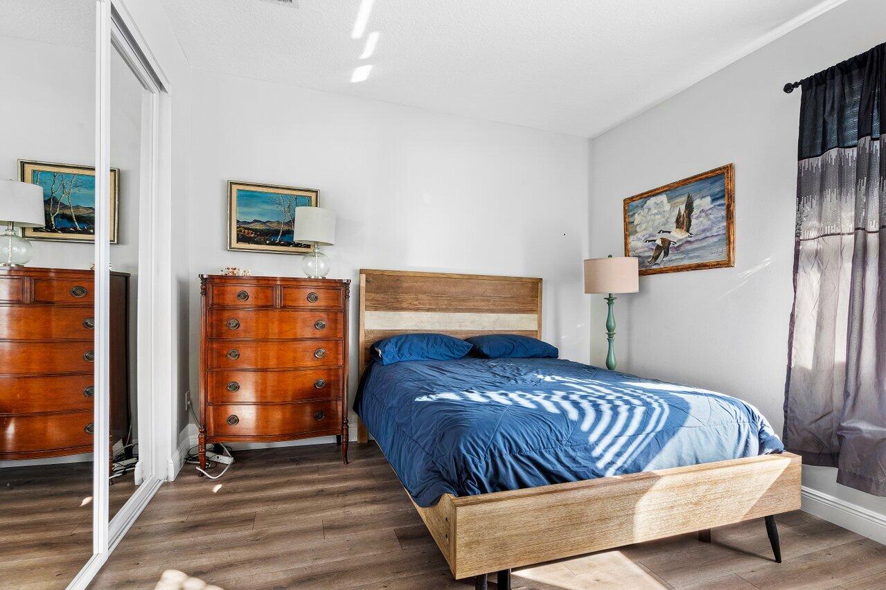 3659 Northwest 5th Terrace Boca Raton, FL 33431 - Photo 24 of 36 a bedroom with a bed and wooden floor