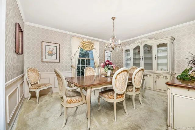 a dining room with furniture a chandelier and window