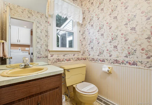 a bathroom with a sink a toilet and mirror