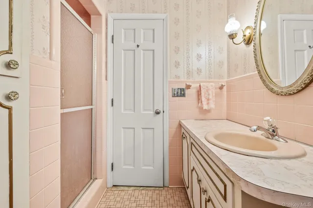 a bathroom with a sink a toilet and a mirror