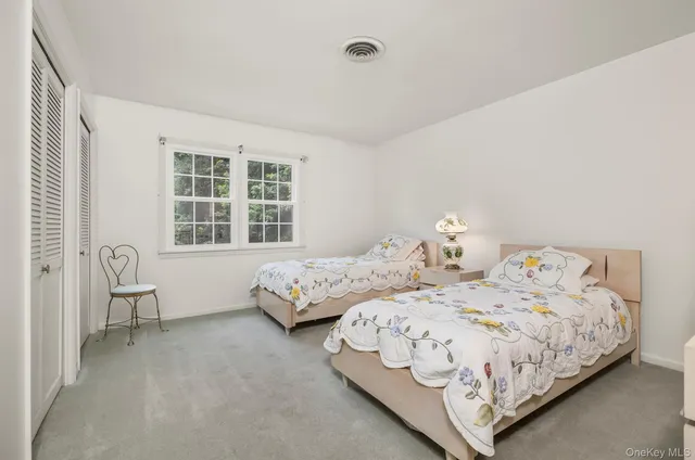 a bedroom with two beds and a window