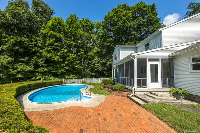 a view of a house with swimming pool and sitting area