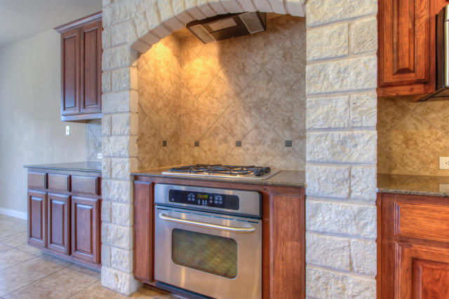321 Limestone Trail Austin, TX 78737 - Photo 5 of 28 a stove top oven sitting inside of a kitchen