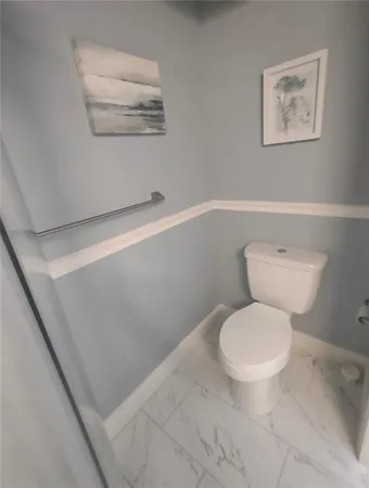 a white toilet sitting next to a white sink