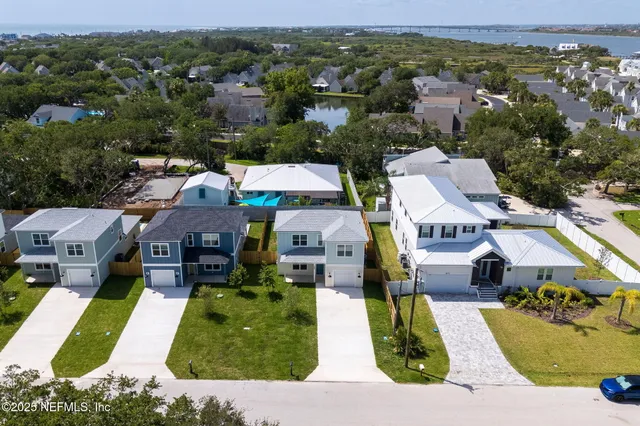 an aerial view of multiple houses with yard